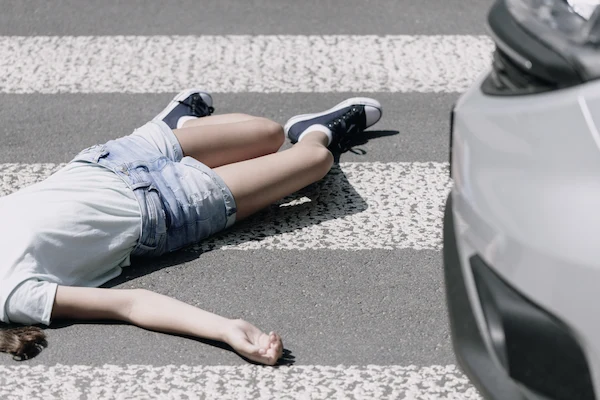 A high angle view shows a child who was hit by a car in a crosswalk.