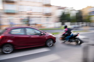 Motion blur crash scene represents bias in Texas motorcycle accident cases.