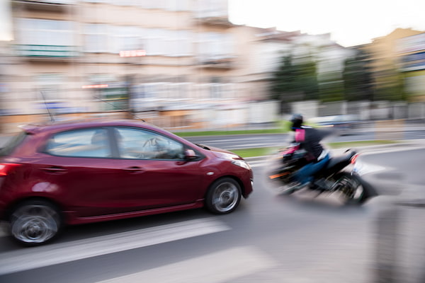 Motion blur crash scene represents bias in Texas motorcycle accident cases.