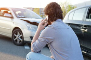 A driver calling the police represents what to do after a car accident in Houston.
